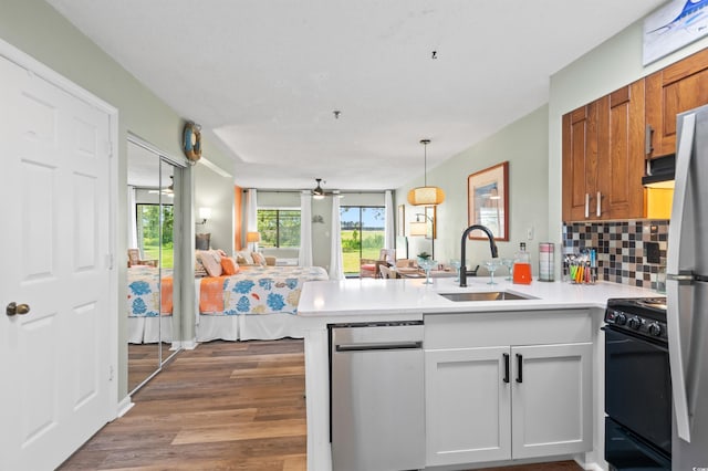 1100 Possum Trot Rd Unit G117, North Myrtle Beach, SC 29582 - kitchen with stainless steel appliances, a peninsula, open floor plan, and light countertops