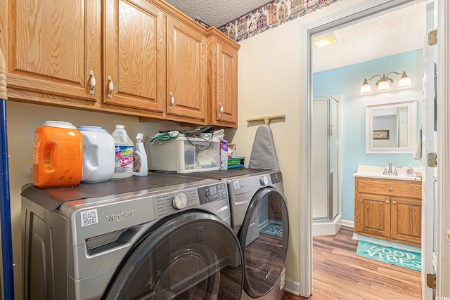 906 Hope Cir, Conway, SC 29527 - washroom featuring independent washer and dryer, a textured ceiling, cabinet space, and light wood finished floors