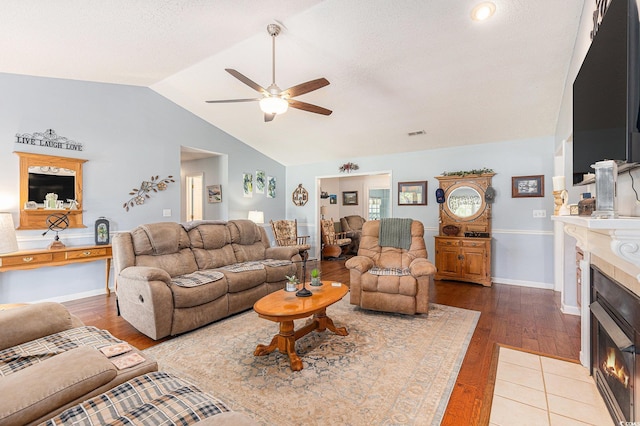 906 Hope Cir, Conway, SC 29527 - living area with a tiled fireplace, ceiling fan, vaulted ceiling, and wood finished floors