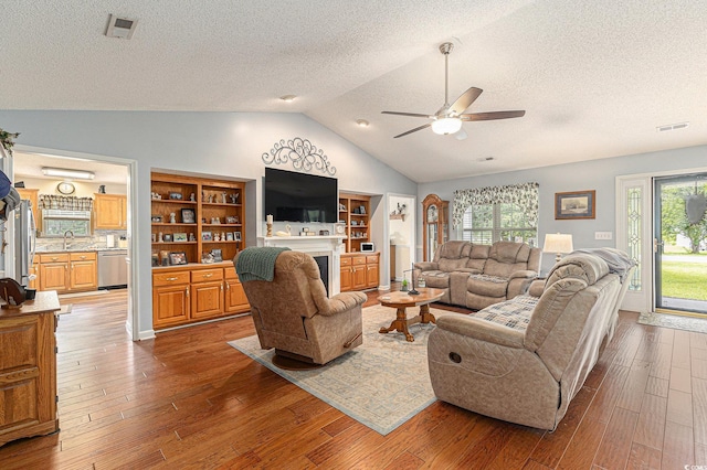 906 Hope Cir, Conway, SC 29527 - living room featuring a fireplace, a textured ceiling, ceiling fan, wood-type flooring, and lofted ceiling