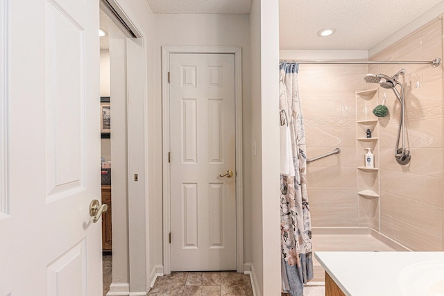 906 Hope Cir, Conway, SC 29527 - bathroom featuring tiled shower, vanity, and a textured ceiling