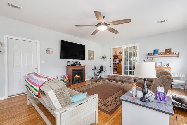 906 Hope Cir, Conway, SC 29527 - living area featuring ceiling fan, a lit fireplace, and light wood-style flooring
