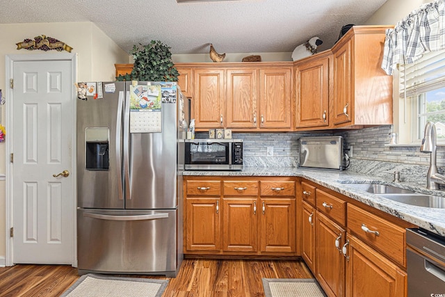 906 Hope Cir, Conway, SC 29527 - kitchen with appliances with stainless steel finishes, light wood-style floors, backsplash, and a textured ceiling