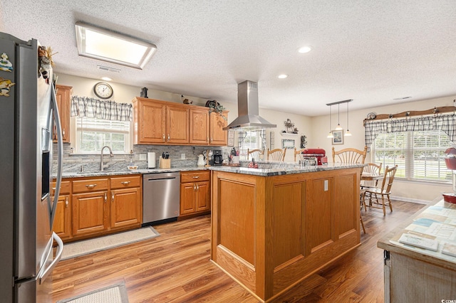 906 Hope Cir, Conway, SC 29527 - kitchen with stainless steel appliances, island range hood, a textured ceiling, light wood finished floors, and light stone countertops