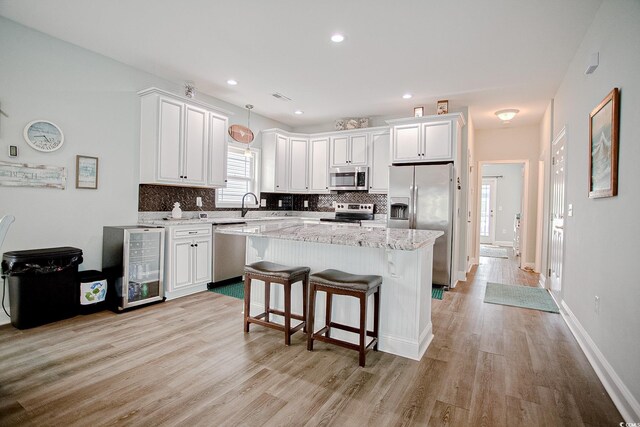 115A 8th Ave N, Surfside Beach, SC 29575 - kitchen featuring stainless steel appliances, decorative backsplash, light wood finished floors, and recessed lighting