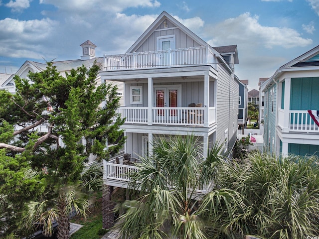 115A 8th Ave N, Surfside Beach, SC 29575 - coastal inspired home with a balcony, board and batten siding, and french doors