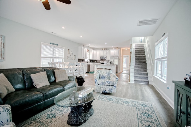 115A 8th Ave N, Surfside Beach, SC 29575 - living room with light wood finished floors, a ceiling fan, stairway, and recessed lighting