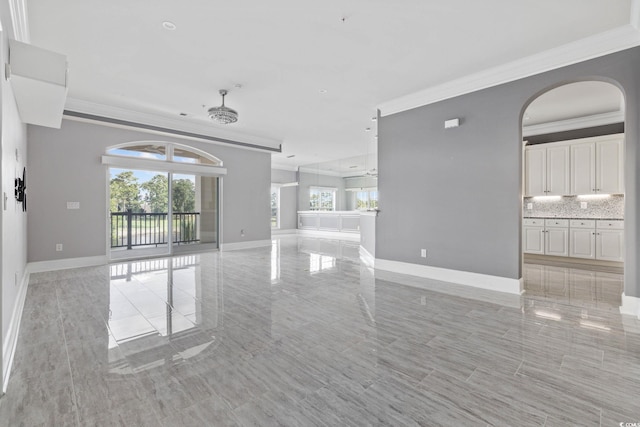 257 Venice Way Unit 2201, Myrtle Beach, SC 29577 - unfurnished living room featuring crown molding and arched walkways