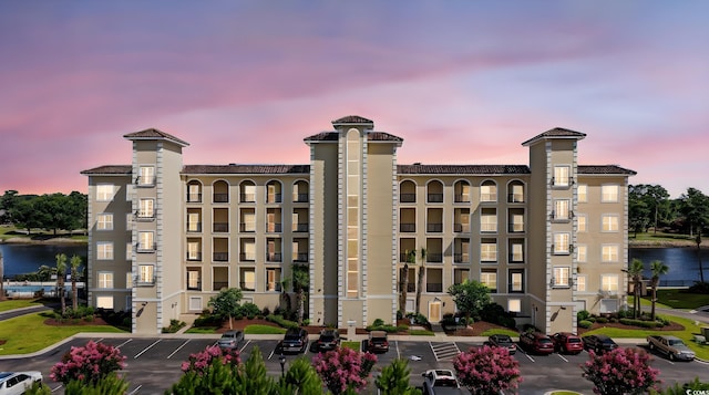 257 Venice Way Unit 2201, Myrtle Beach, SC 29577 - property at dusk featuring uncovered parking and a water view
