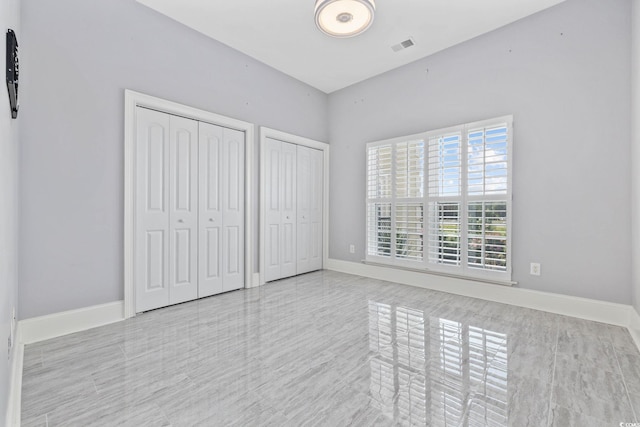 257 Venice Way Unit 2201, Myrtle Beach, SC 29577 - unfurnished bedroom featuring two closets and baseboards