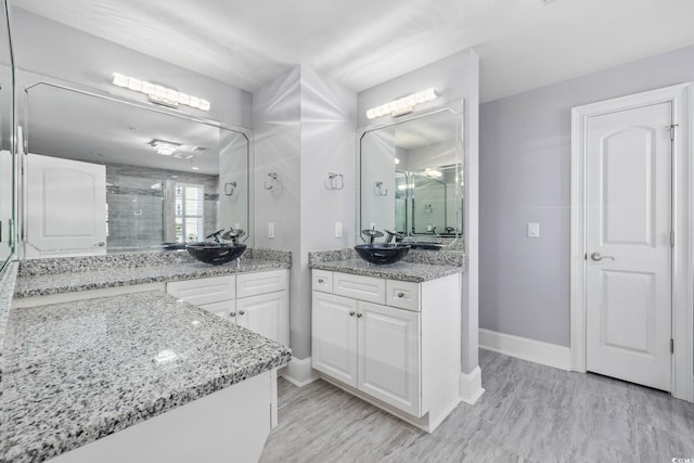 257 Venice Way Unit 2201, Myrtle Beach, SC 29577 - full bathroom with a stall shower, two vanities, and wood finished floors