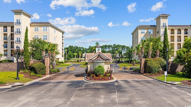 257 Venice Way Unit 2201, Myrtle Beach, SC 29577 - view of asphalt road with curbs, a gate, a gated entry, and street lights