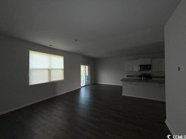 2061 Ridgedale Dr, Conway, SC 29526 - unfurnished living room with dark wood finished floors and baseboards