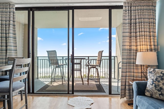 5523 N Ocean Blvd Unit 908, Myrtle Beach, SC 29577 - doorway with wood finished floors, expansive windows, and healthy amount of natural light