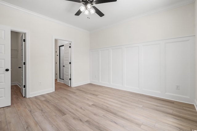 1712 26th Ave N, North Myrtle Beach, SC 29582 - unfurnished bedroom with crown molding, light wood-type flooring, a decorative wall, wainscoting, and ceiling fan