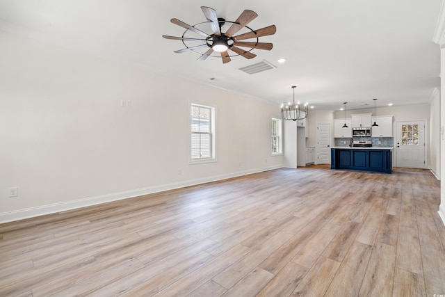 1712 26th Ave N, North Myrtle Beach, SC 29582 - unfurnished living room featuring a chandelier, ornamental molding, ceiling fan, recessed lighting, and light wood-style flooring