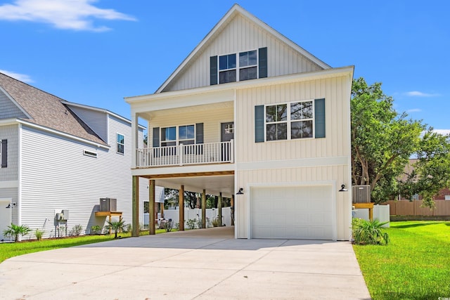 1712 26th Ave N, North Myrtle Beach, SC 29582 - view of front facade featuring a carport, board and batten siding, driveway, an attached garage, and a front lawn