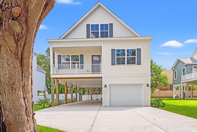 1712 26th Ave N, North Myrtle Beach, SC 29582 - coastal home with a carport, concrete driveway, an attached garage, covered porch, and board and batten siding