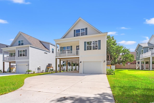 1712 26th Ave N, North Myrtle Beach, SC 29582 - coastal home with an attached garage, driveway, a carport, a front lawn, and board and batten siding