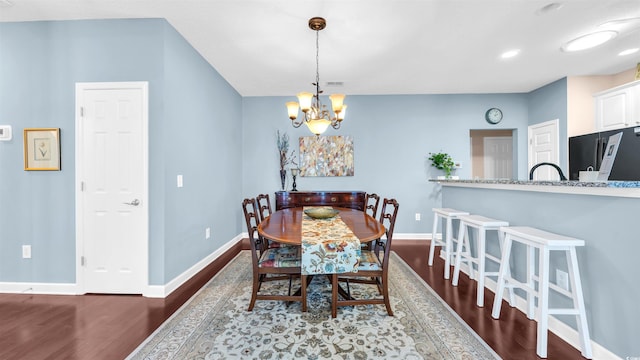 173 Knight Cir Unit 1, Pawleys Island, SC 29585 - dining room with a chandelier and dark wood-type flooring