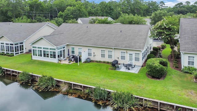 173 Knight Cir Unit 1, Pawleys Island, SC 29585 - back of house featuring roof with shingles, a patio, a water view, and a lawn