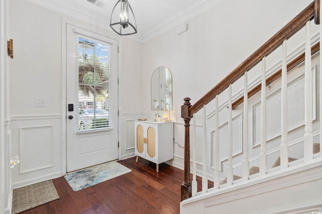 617 Carolina Farms Blvd, Myrtle Beach, SC 29579 - entrance foyer featuring dark wood-style floors, crown molding, wainscoting, a decorative wall, and a chandelier