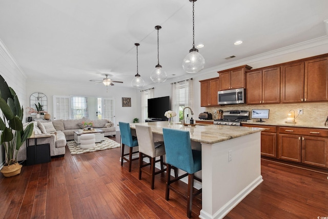 617 Carolina Farms Blvd, Myrtle Beach, SC 29579 - kitchen with stainless steel appliances, brown cabinets, a kitchen bar, open floor plan, and ornamental molding