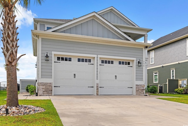 206 Palmetto Harbour Dr, North Myrtle Beach, SC 29582 - view of front of house featuring board and batten siding, stone siding, concrete driveway, and a garage