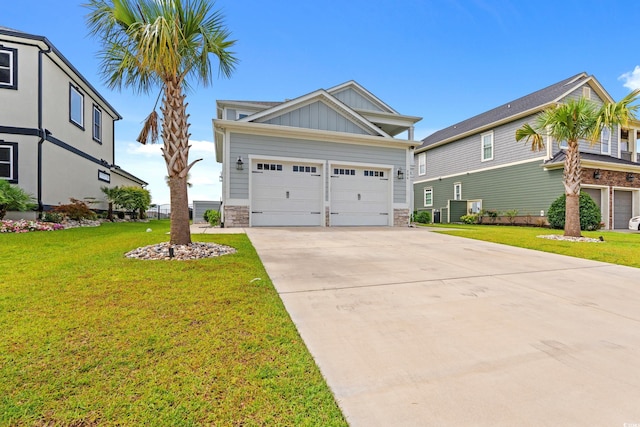 206 Palmetto Harbour Dr, North Myrtle Beach, SC 29582 - craftsman-style house with board and batten siding, concrete driveway, stone siding, and a front yard
