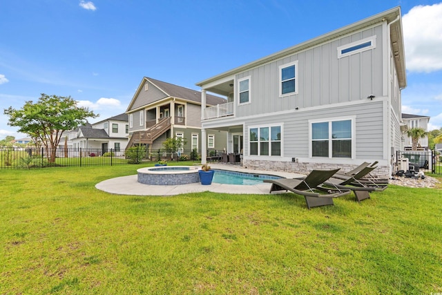 206 Palmetto Harbour Dr, North Myrtle Beach, SC 29582 - back of property with board and batten siding, a balcony, a pool with connected hot tub, and a patio