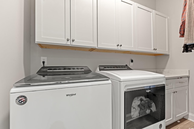 206 Palmetto Harbour Dr, North Myrtle Beach, SC 29582 - laundry area with washing machine and clothes dryer, cabinet space, and light wood-type flooring