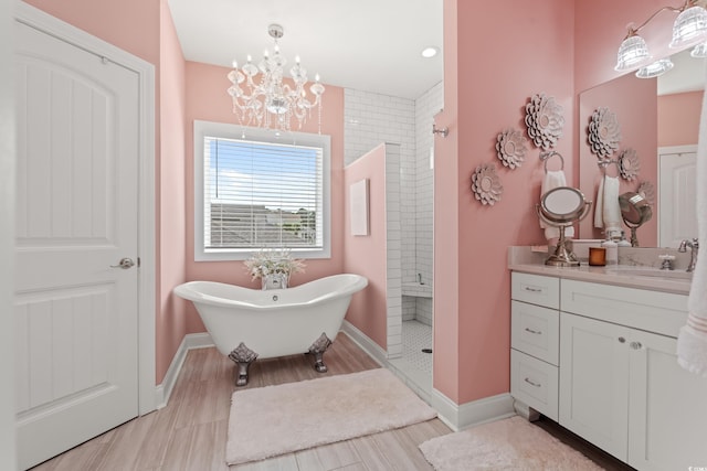 206 Palmetto Harbour Dr, North Myrtle Beach, SC 29582 - full bath featuring vanity, tiled shower, a freestanding tub, a chandelier, and wood finished floors