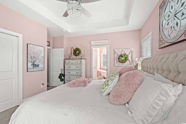 206 Palmetto Harbour Dr, North Myrtle Beach, SC 29582 - carpeted bedroom featuring a raised ceiling, ensuite bath, and ceiling fan