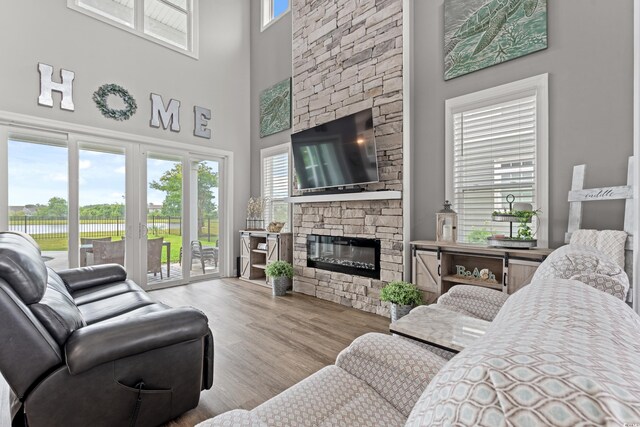206 Palmetto Harbour Dr, North Myrtle Beach, SC 29582 - living room with a stone fireplace, wood finished floors, a high ceiling, and a water view