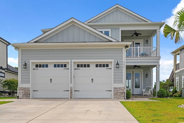 206 Palmetto Harbour Dr, North Myrtle Beach, SC 29582 - view of front of house featuring a balcony, a ceiling fan, stone siding, concrete driveway, and board and batten siding