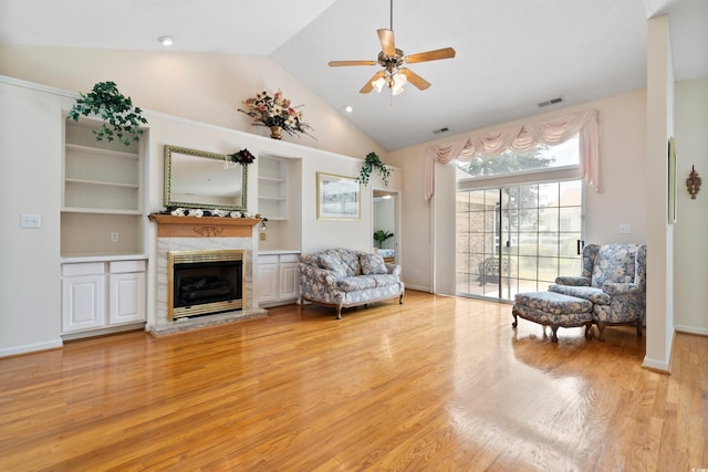 2443 Glen Dr, Little River, SC 29566 - living area with a fireplace with raised hearth, light wood-type flooring, lofted ceiling, and ceiling fan