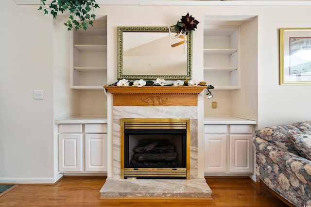2443 Glen Dr, Little River, SC 29566 - living room featuring wood finished floors, built in features, and a fireplace