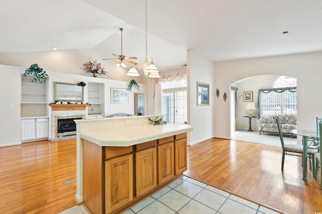 2443 Glen Dr, Little River, SC 29566 - kitchen with open floor plan, healthy amount of natural light, tile counters, a ceiling fan, and lofted ceiling