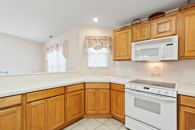 2443 Glen Dr, Little River, SC 29566 - kitchen featuring white appliances, decorative backsplash, light tile patterned flooring, brown cabinetry, and recessed lighting