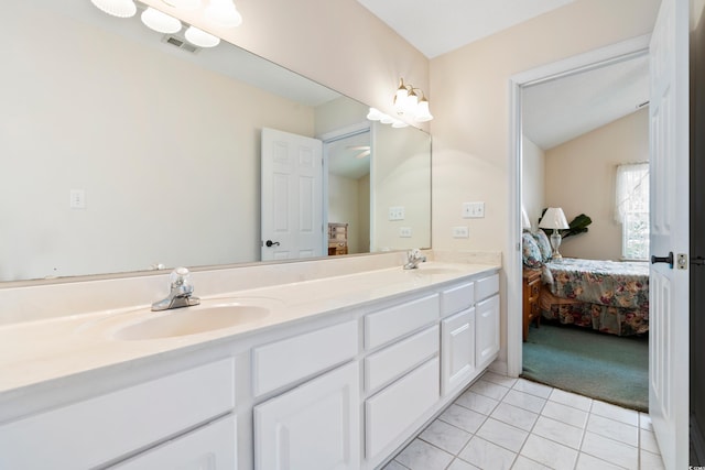 2443 Glen Dr, Little River, SC 29566 - ensuite bathroom with double vanity, vaulted ceiling, and tile patterned floors