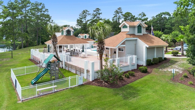 2443 Glen Dr, Little River, SC 29566 - back of house featuring a playground, a fenced backyard, a shingled roof, and a patio area
