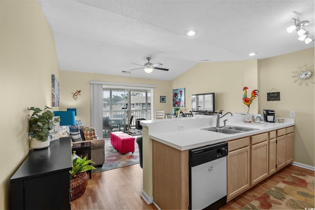 202 Landing Rd Unit 202H, North Myrtle Beach, SC 29582 - kitchen featuring dishwasher, a peninsula, wood finished floors, vaulted ceiling, and light countertops