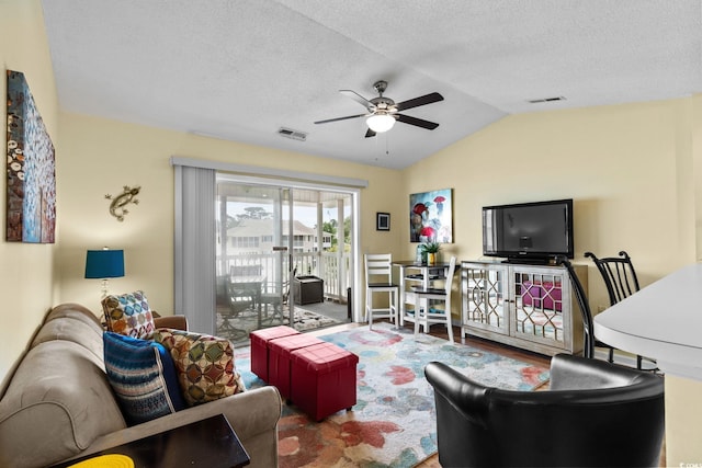 202 Landing Rd Unit 202H, North Myrtle Beach, SC 29582 - living room featuring a ceiling fan, lofted ceiling, wood finished floors, and a textured ceiling