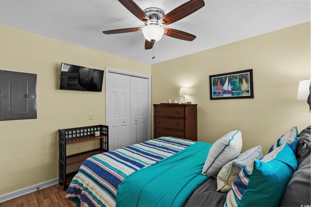 202 Landing Rd Unit 202H, North Myrtle Beach, SC 29582 - bedroom featuring electric panel, wood finished floors, a closet, and a ceiling fan