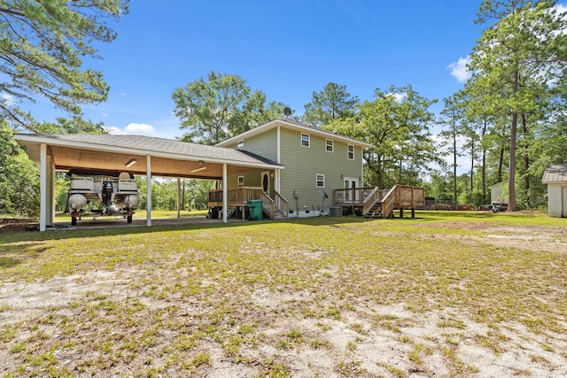 315 N River Pines Rd, Mullins, SC 29574 - rear view of house with stairs, a carport, a deck, and a yard