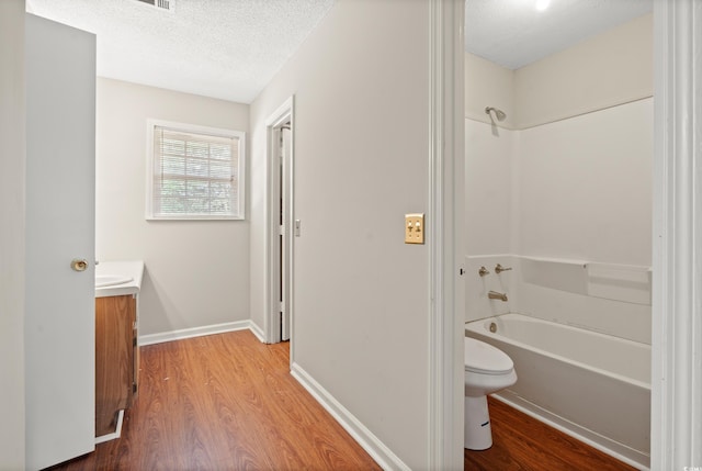 315 N River Pines Rd, Mullins, SC 29574 - full bath featuring wood finished floors, vanity, washtub / shower combination, and a textured ceiling