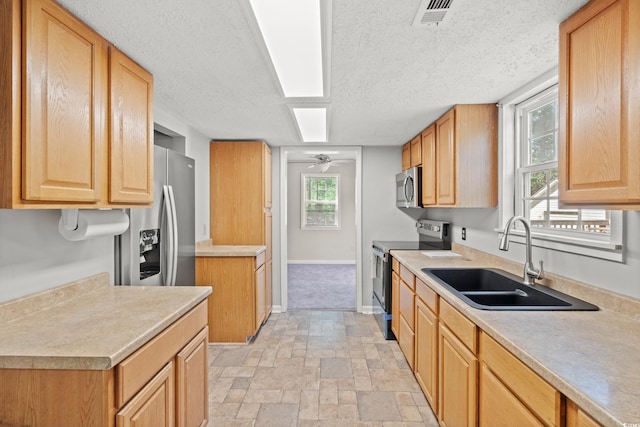 315 N River Pines Rd, Mullins, SC 29574 - kitchen with stainless steel appliances, light countertops, a ceiling fan, a textured ceiling, and light stone finish floors