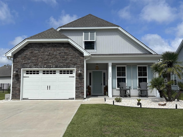240 Sundew Loop, Little River, SC 29566 - view of front facade with stone siding, a porch, driveway, a front lawn, and an attached garage