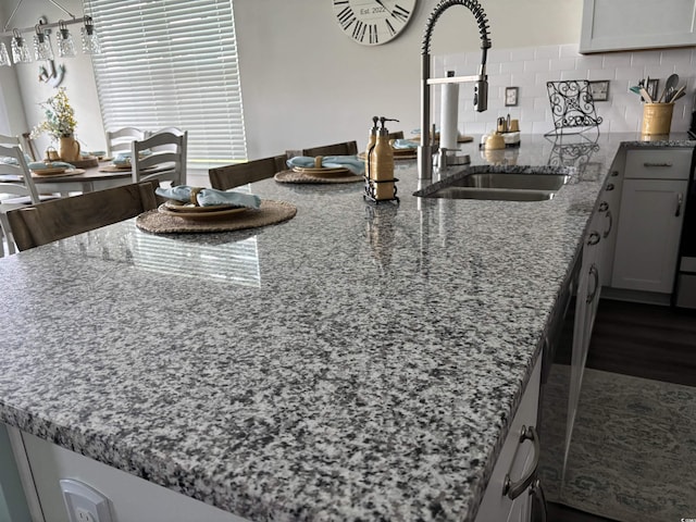 240 Sundew Loop, Little River, SC 29566 - kitchen with stone counters, a peninsula, and tasteful backsplash