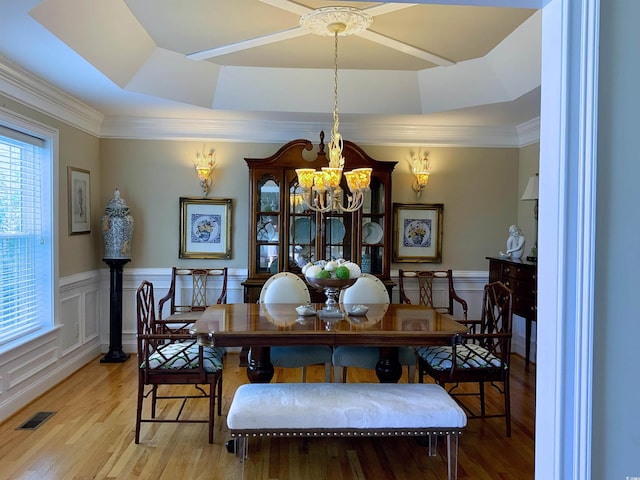 1605 Waterway Dr, North Myrtle Beach, SC 29582 - dining room featuring a chandelier, wood finished floors, a raised ceiling, wainscoting, and crown molding